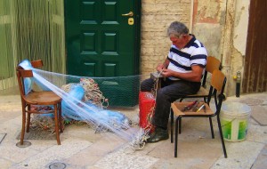 man fixing fishing net